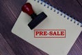 Red Handle Rubber Stamper and Pre-Sale text isolated on the table