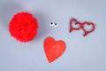 Red handmade diy monster pom pom from yarn, chenille stems in shape heart