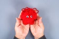 Red handmade diy monster pom pom from yarn, chenille stems in shape heart