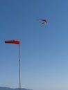 Red hang glider above with wind cone Royalty Free Stock Photo
