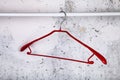 Red hanger on a gray wall Royalty Free Stock Photo