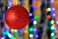 Red hanging ball, christmas decoration with blurred lights background. Royalty Free Stock Photo