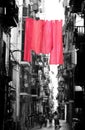 red hanging bedclothes on the narrow street in Naples City