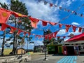 Red hanging flags outdoors next to street cafes at Halifax waterfront