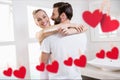 Red hanging heart and couple embracing each other Royalty Free Stock Photo