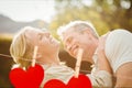 Red hanging heart and couple embracing each other Royalty Free Stock Photo
