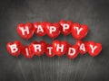 Red happy birthday heart shape air balloons on a concrete background Royalty Free Stock Photo