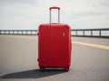 Red Suitcase on Empty Road in Open Landscape Royalty Free Stock Photo