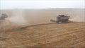 Red harvester machine drive on rural field - grain harvesting on a Sunny summer day, side view. Harvester on the field