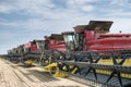 eight red harvesters lined up in one row. Royalty Free Stock Photo