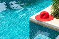 Red hat on the Blue water swimming pool Royalty Free Stock Photo