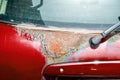 Red hatchback car back or fifth door damaged rusty and corroded paint spots