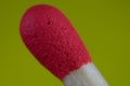 red head of flammable material of phosphorus stick with yellow background