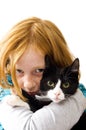 Red head girl holding a black white kitten Royalty Free Stock Photo