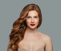 Red head girl with long shiny curly hair. Beautiful model woman with wavy hairstyle