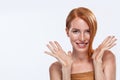 Red head girl with long and shiny wavy hair. Beautiful model woman with curly ginger hairstyle and frackles. Royalty Free Stock Photo