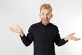 Red-head man dont know or not sure. Skeptic, unsure, uncertain, doubts concept. Young white guy in black wear is looking sceptical Royalty Free Stock Photo