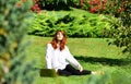 Red head young woman. Spring Beautiful romantic red haired girl in spring garden. Young model looking at camera. Royalty Free Stock Photo