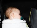 Red-headed Baby Boy Sleeping in Carriage Wrapped with a Pacifier Royalty Free Stock Photo