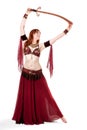 Red-headed belly dancer posing with sword Royalty Free Stock Photo