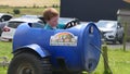 Red headed boy with a blue t-shirt having fun having at Sperrin Fun and Heritage Farm Tyrone N Ireland