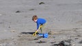 Red headed boy building sandcastles Bucket spade on a sandy beach Royalty Free Stock Photo
