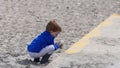 Red headed boy playing with Bucket spade and Digger on sandy beach Royalty Free Stock Photo