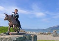 Red headed boy riding a statue Bull Ireland