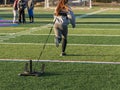 Red headed high school female pulling weighted sled Royalty Free Stock Photo