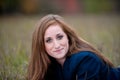 Red-headed teen girl lying in grass Royalty Free Stock Photo