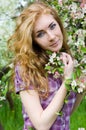Red-headed woman under cherry tree Royalty Free Stock Photo