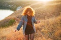 A red headed young woman walking smiling near a river Royalty Free Stock Photo