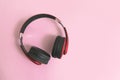 Red headphone on pink background. copy space