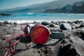 Red headphones on the black sand, ocean views