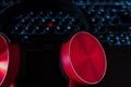 Red headphones,flat lay on laptop keyboard.Black blue glows keyboard.Closeup image