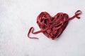 Red heart and arrow made of beetroot vegan pasta.