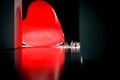 Red heart balloon laid on ceramic tiles floor.