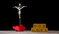 The red heart on black black background including cross beside the heart. The cross is the symbol of Christian religion. God love Royalty Free Stock Photo