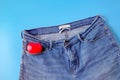 Red heart in blue jeans pocket, concept romance Royalty Free Stock Photo