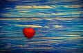 Red heart on blue wooden table background. Royalty Free Stock Photo