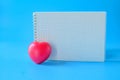 Red heart and booknote on background Royalty Free Stock Photo