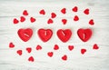 Red heart candles with little decorative hearts on the wooden ba Royalty Free Stock Photo