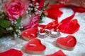 Red heart candles . Red rose petals . Gold wedding rings Royalty Free Stock Photo