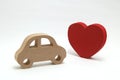 Red heart and a car on white background. Safe driving concept. Royalty Free Stock Photo