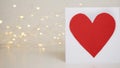 Red heart card on bokeh background with hearts. Valentine's day celebration or love concept. Copy space Royalty Free Stock Photo