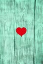 The red heart is carved in a wooden board of green color. Background. Royalty Free Stock Photo