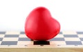 Red heart on the chess desk