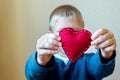 Red heart in child hands