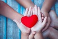 Red heart in child and parent hands with love and harmony Royalty Free Stock Photo