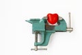 Red heart clamped in vise, pain with stenocardia Royalty Free Stock Photo